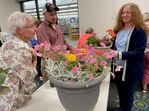 This photo shows Friends members learning how to create a fresh flower planter.