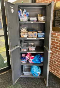 This is a picture of the personal pantry open. There are objects in it that people can take if they need them.