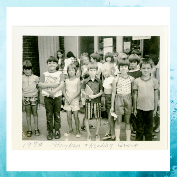 Here is a photo of a group of children at the library enjoying storytimes. The picture is probably from the 1970's.